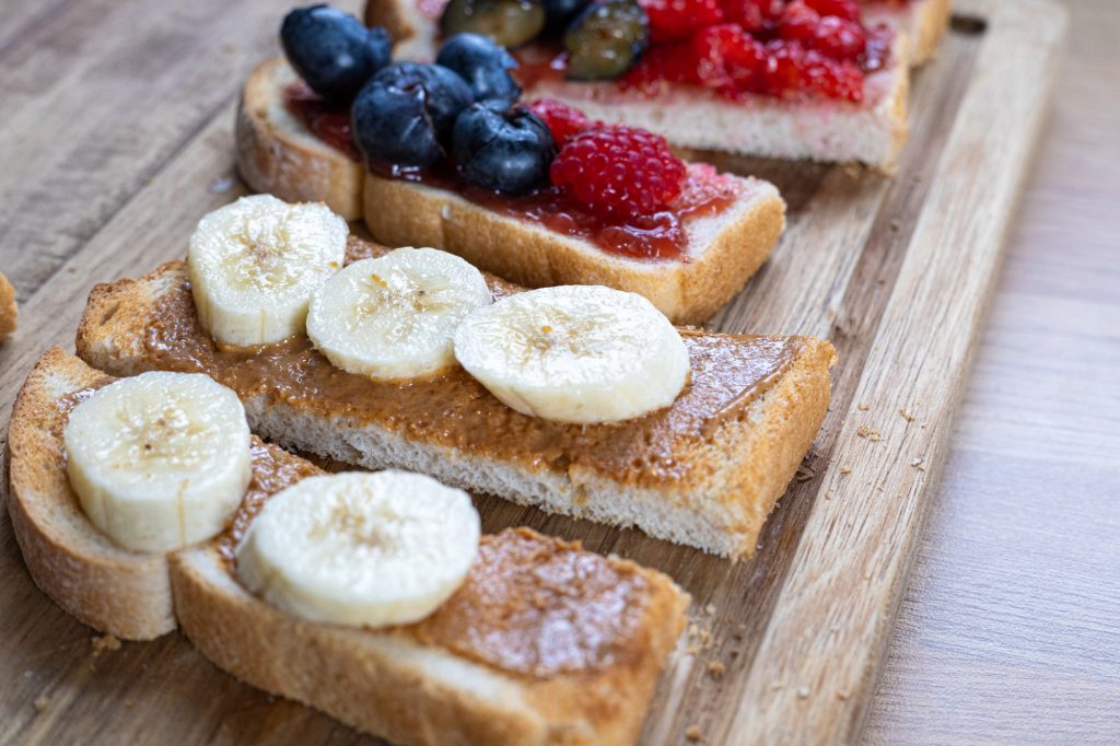 Baby led weaning toast means lots of toppings! Here we have peanut butter and banana with berry toast fingers.